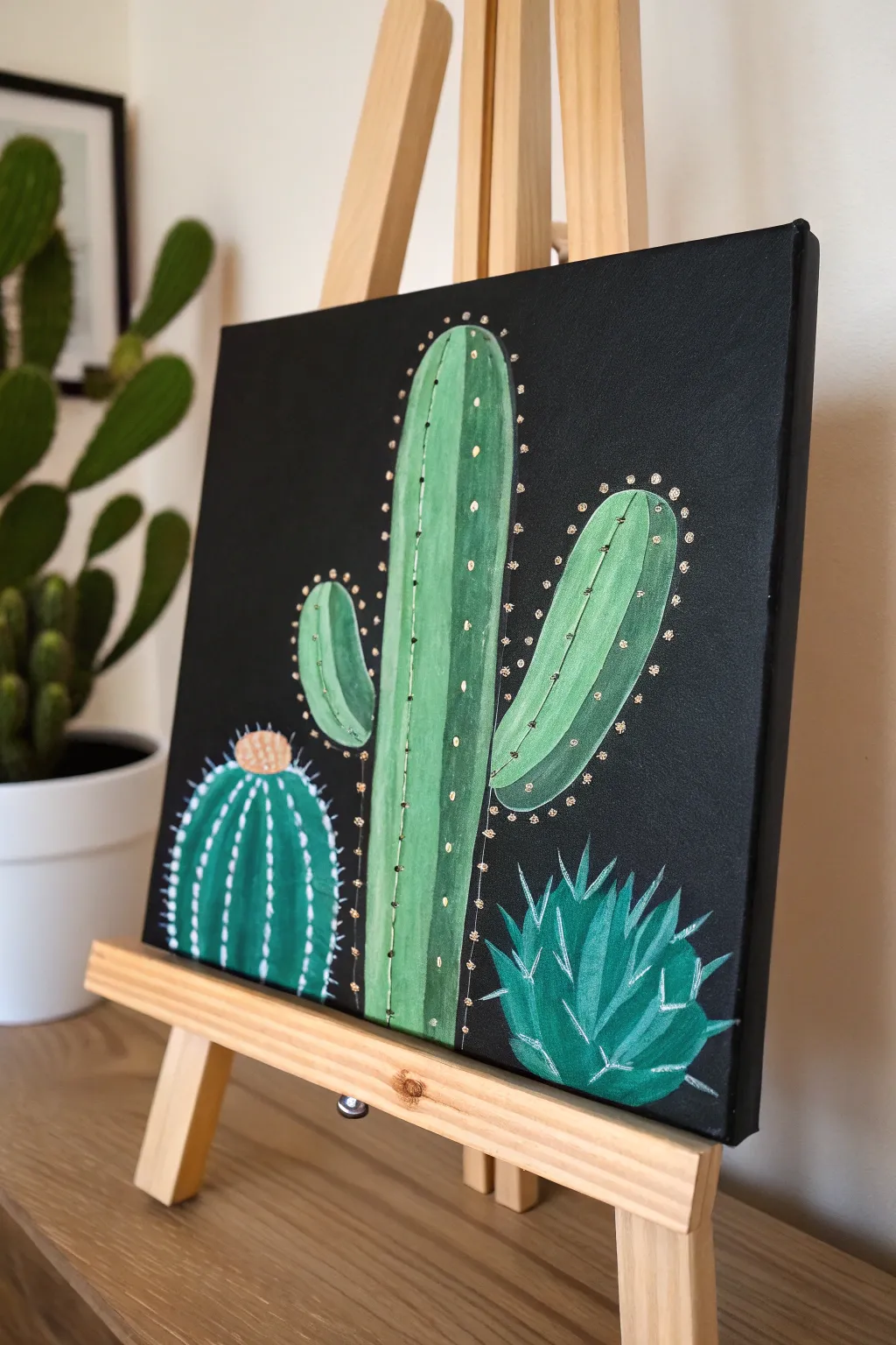 Three beginner-friendly cacti pop on a black canvas with bright highlights and minimalist charm