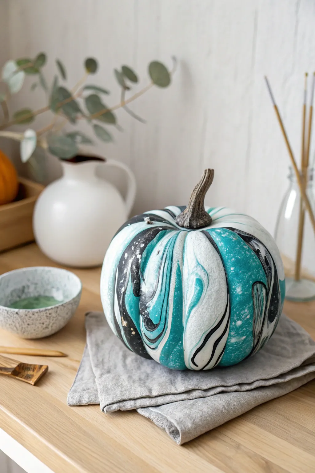 Water-marbled teal swirls turn a faux pumpkin into clean Scandinavian-boho fall decor.