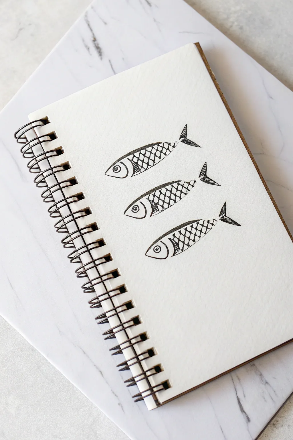 Three mini fish studies showing dot, crosshatch, and plated scales for quick texture practice