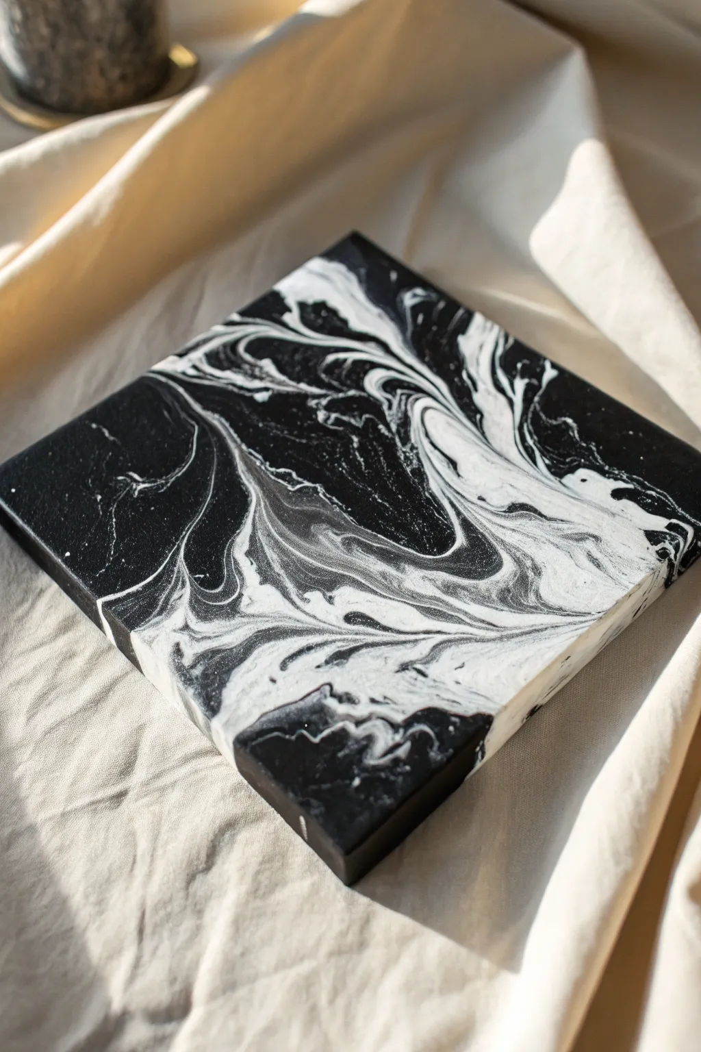 Bold black-and-white acrylic pour close-up with crisp edges and soft marbling for dramatic contrast