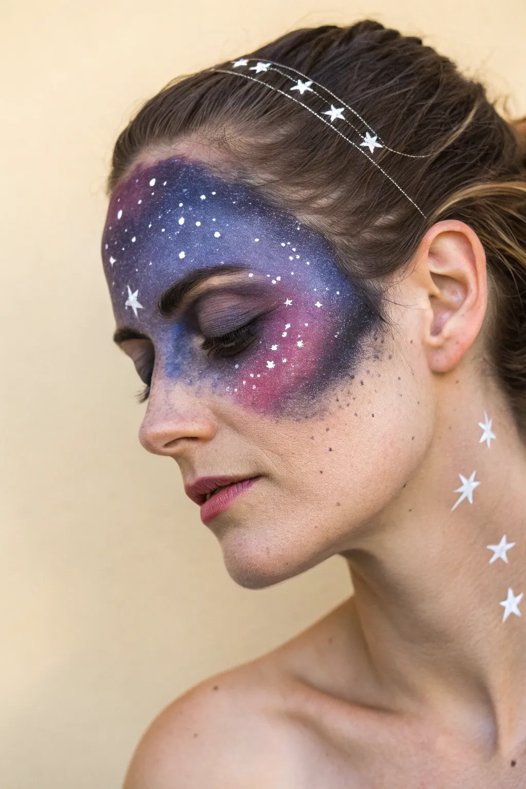 Channel celestial vibes with this artistic galaxy nebula face paint idea for Halloween.