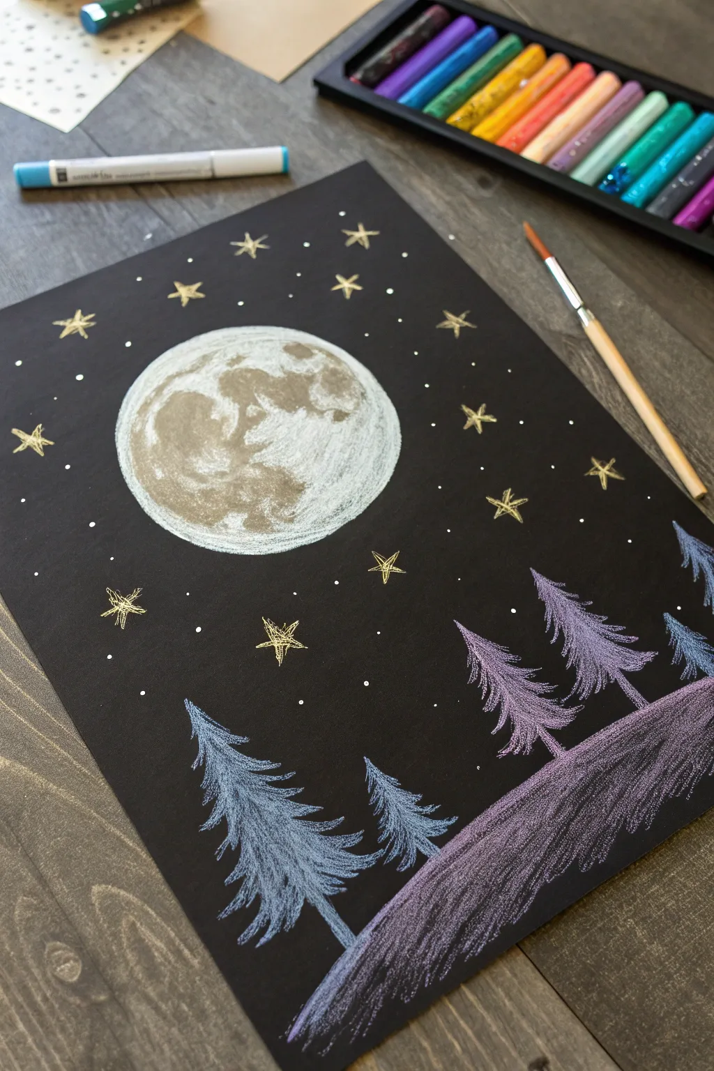Black paper nightscape oil pastel with a glowing moon and bright stars in high contrast