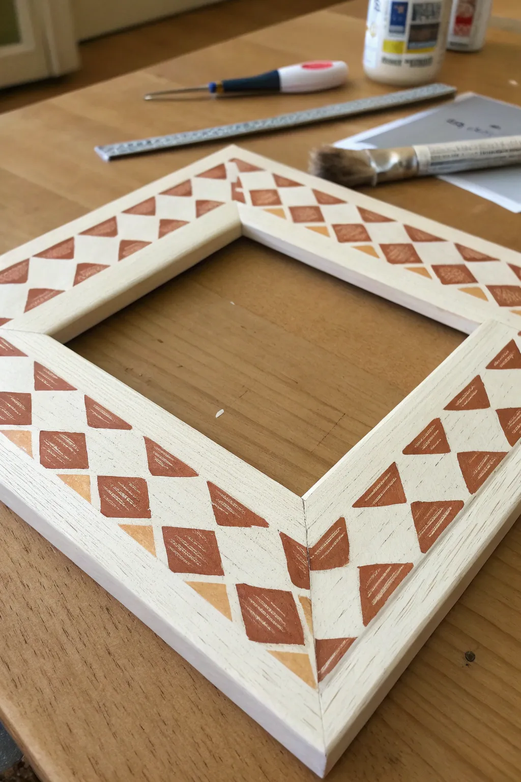 Stenciled diamonds with a hand-drawn feel, a simple frame idea that looks crafted and cozy.