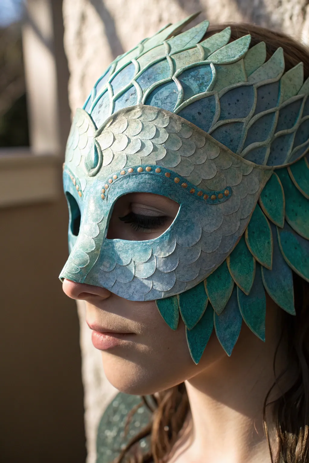Ocean-inspired paper mache mask with raised scales and shimmering blue-green highlights