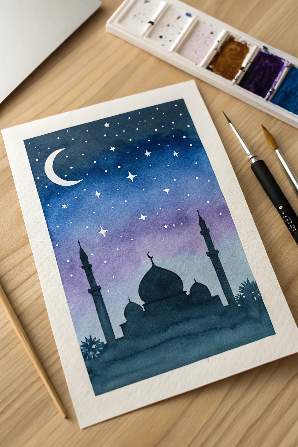 Simple mosque outline with an indigo watercolor sky wash and delicate white star splatter