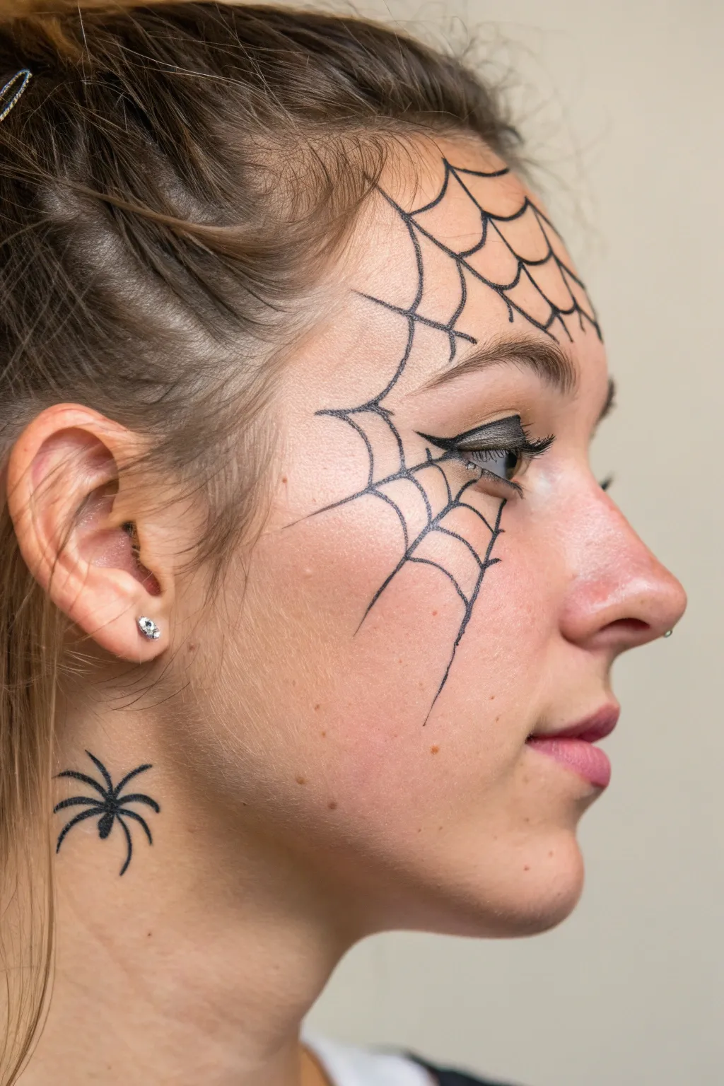 Quick spider and web corner accent with thin lines and clean geometry for an easy cheek detail