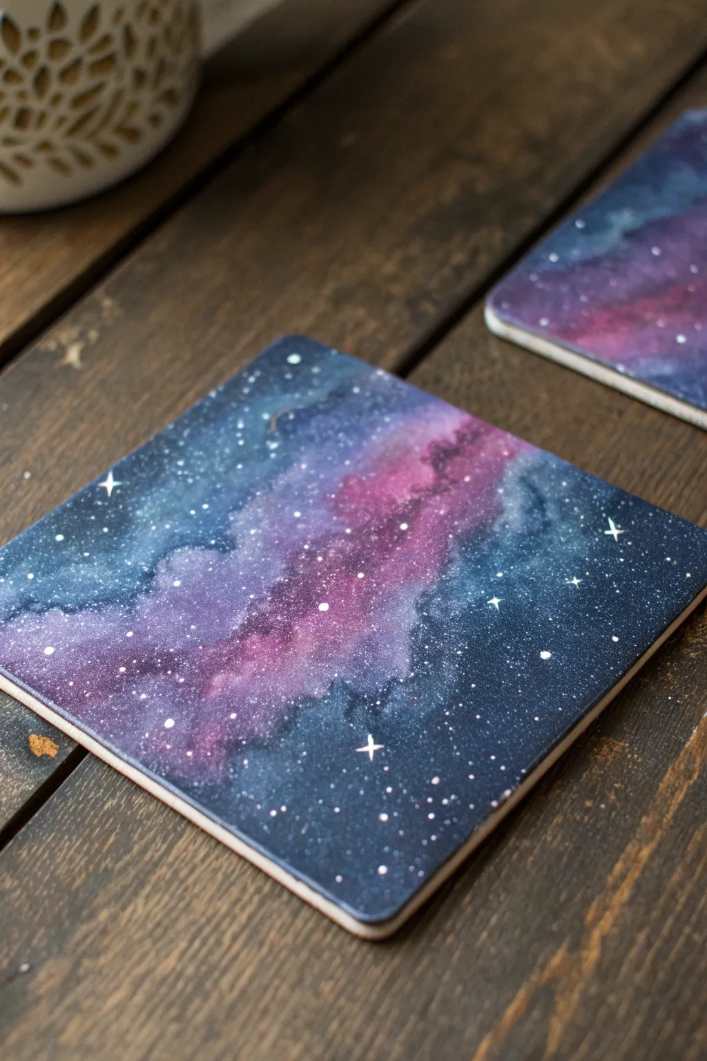 Square galaxy coaster in deep purples and blues with delicate splatter stars, minimal mood