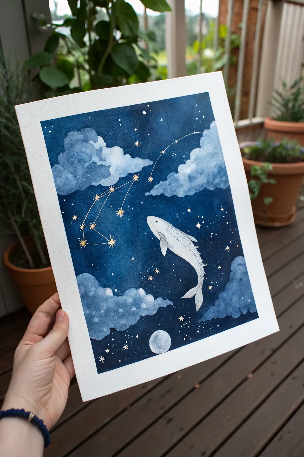 A dreamy fish-shaped cloud glides through a starry night, like an upside-down ocean.