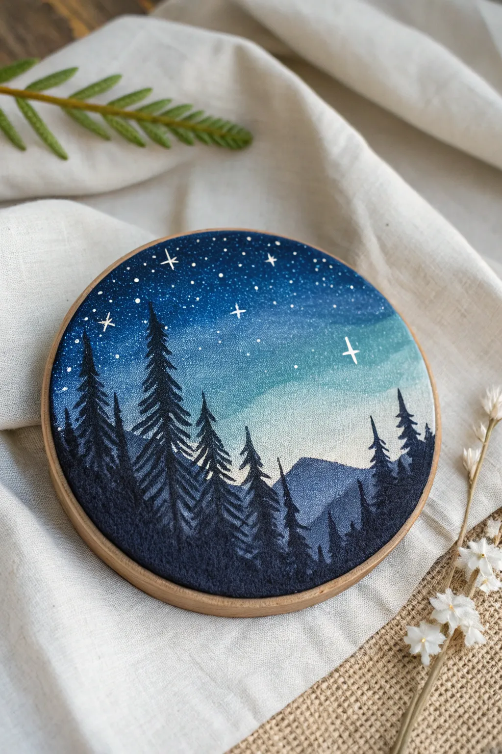 Recycled round canvas night-sky scene with crisp silhouettes and delicate star-speckle details
