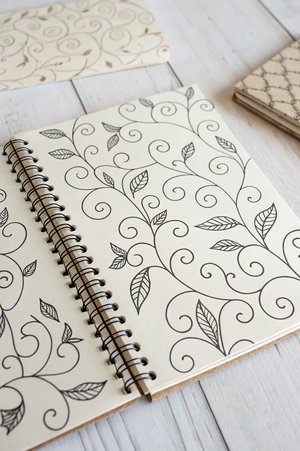 Hand-drawn curling vine scrollwork in crisp ink, with a bold-outline swatch for contrast.