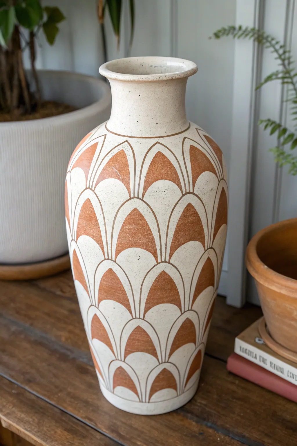 Stencil repeats create crisp, modern patterns on a painted ceramic vase with clean minimalist style.