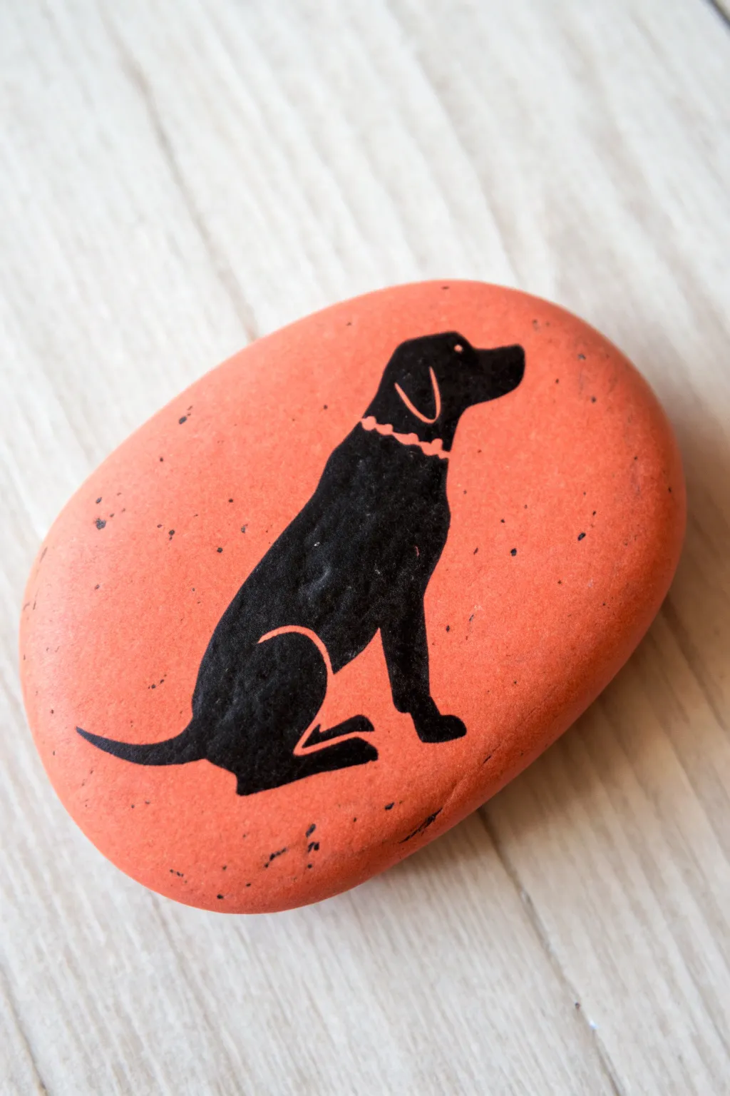 Simple dog silhouette rock: crisp black on a bright base for an easy, modern DIY look