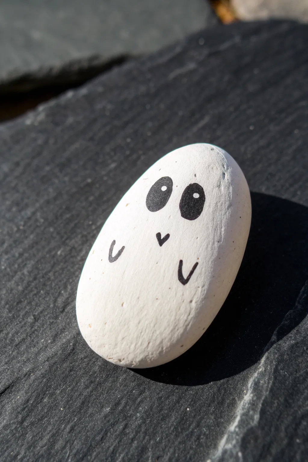 Simple ghost rock with a soft hovering shadow, perfect minimalist Halloween crafting.