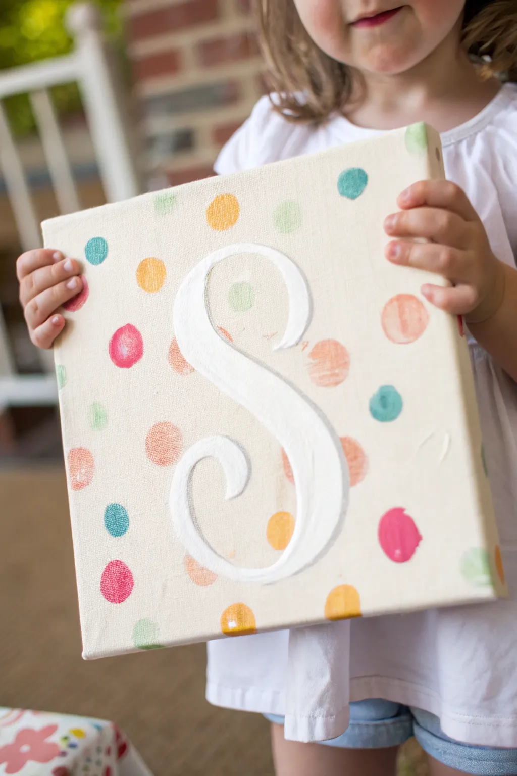 DIY monogram canvas party favor: a bright initial artwork kids can take home after painting.
