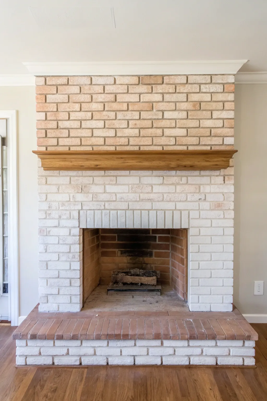 Soft ombré brickwork that moves from airy light tones to grounded warmth at the hearth