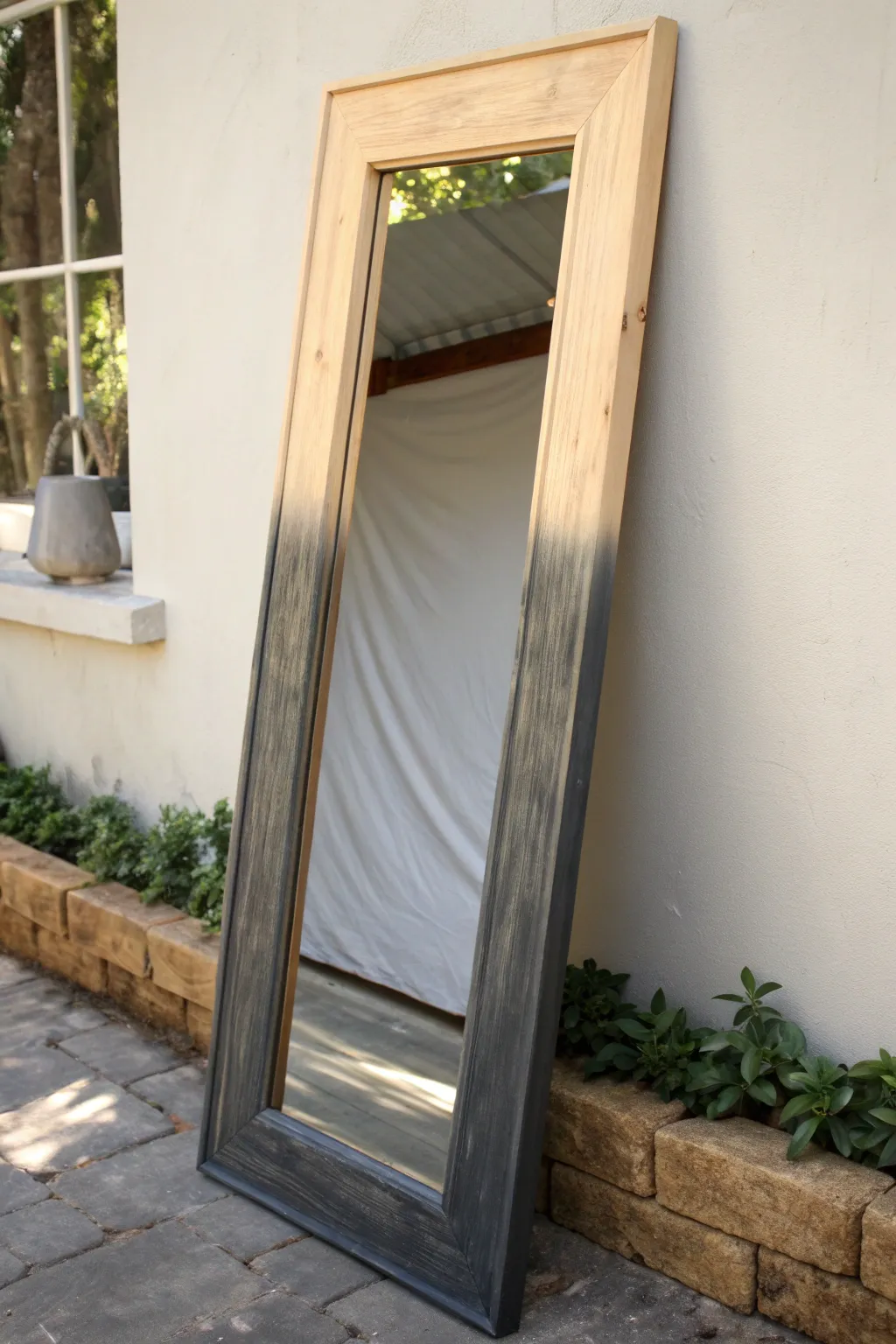 Minimalist ombre mirror frame, fading from rich charcoal to airy ivory in soft daylight