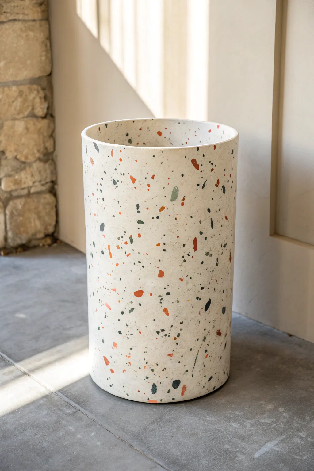 Terrazzo speckles transform a simple trash can into a chic minimalist accent with artisan charm.