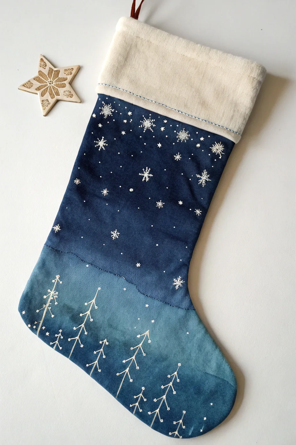 Moody night-sky stocking with stars and snowy speckles, softly shaded cuff for depth