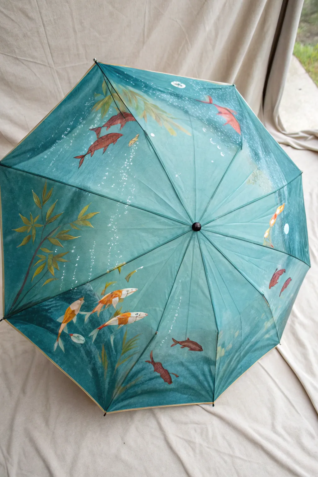 Top view umbrella painted as a koi pond, rippling water and bright fish in a calming circle