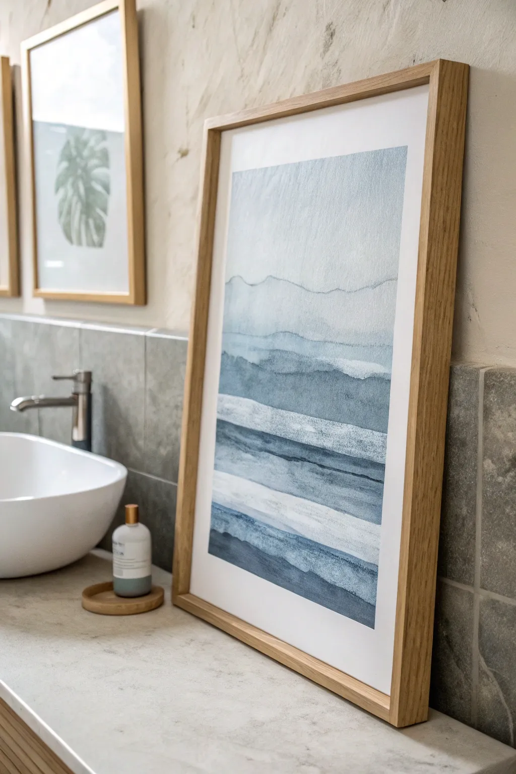 Monochrome blue-gray wall art smooths visual clutter and makes a tiny bathroom feel bigger.