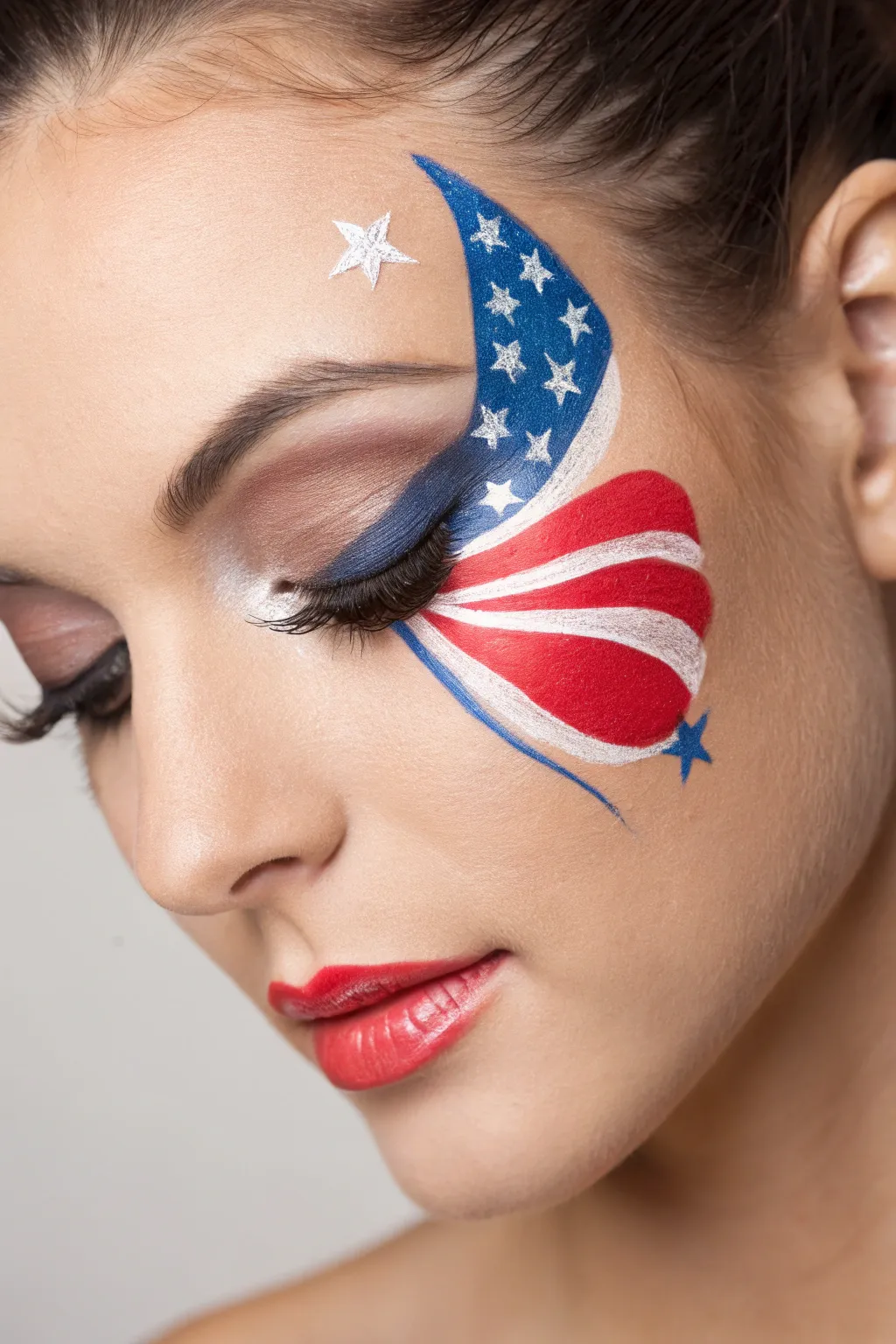 Easy patriotic butterfly wing face paint in red, white and blue with simple star details.