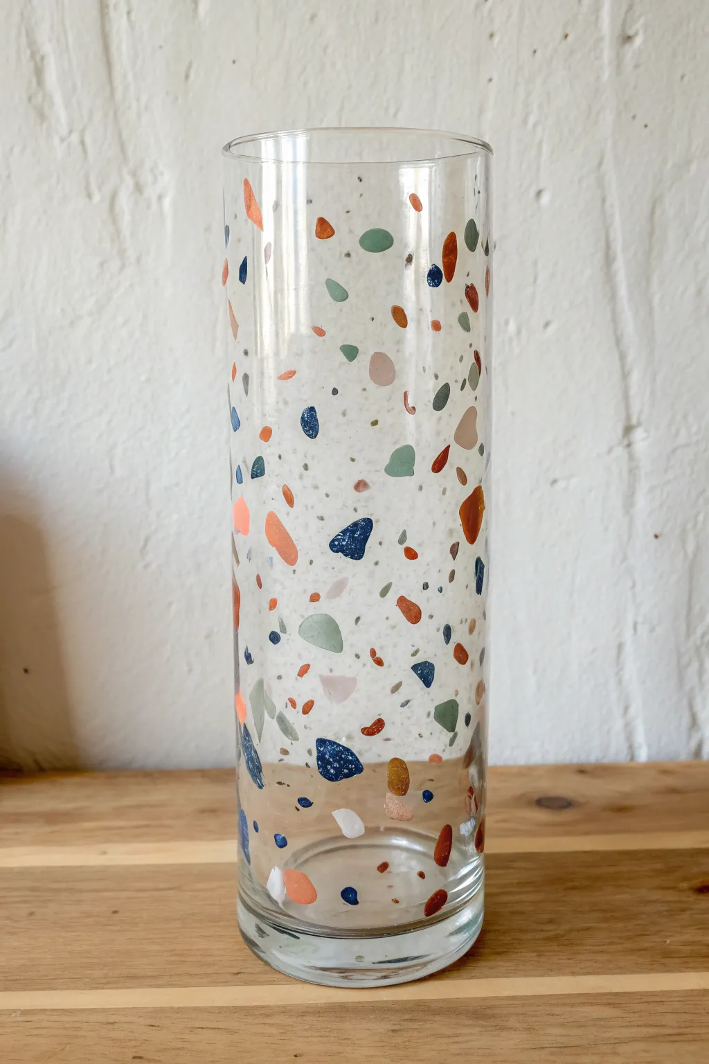 Terrazzo confetti glass painting with airy clear space, muted chips, and bold color pops.