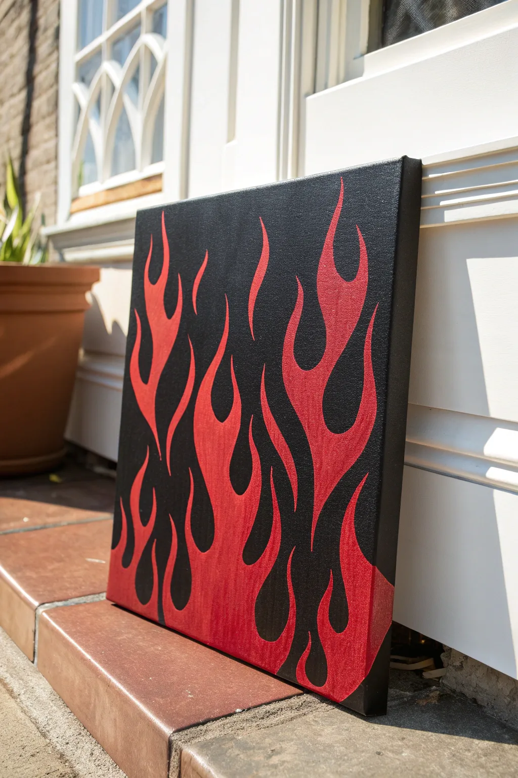 Crisp black and red negative-space flames for a bold minimalist statement painting idea.