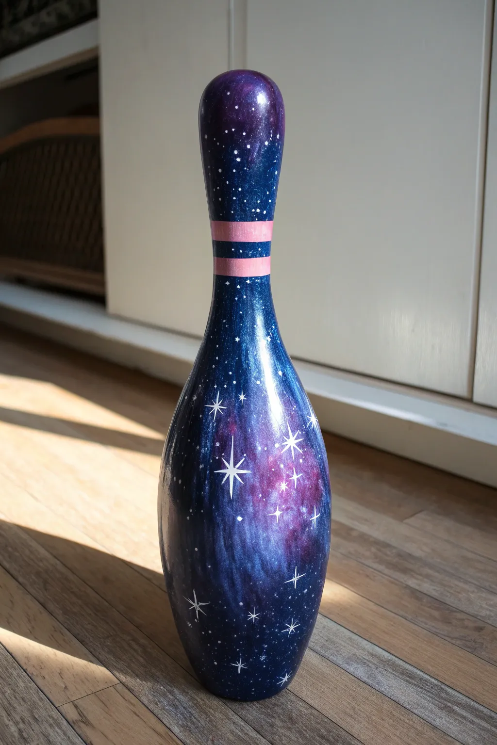Night-sky galaxy bowling pin DIY in deep blues with star splatter and a soft nebula glow
