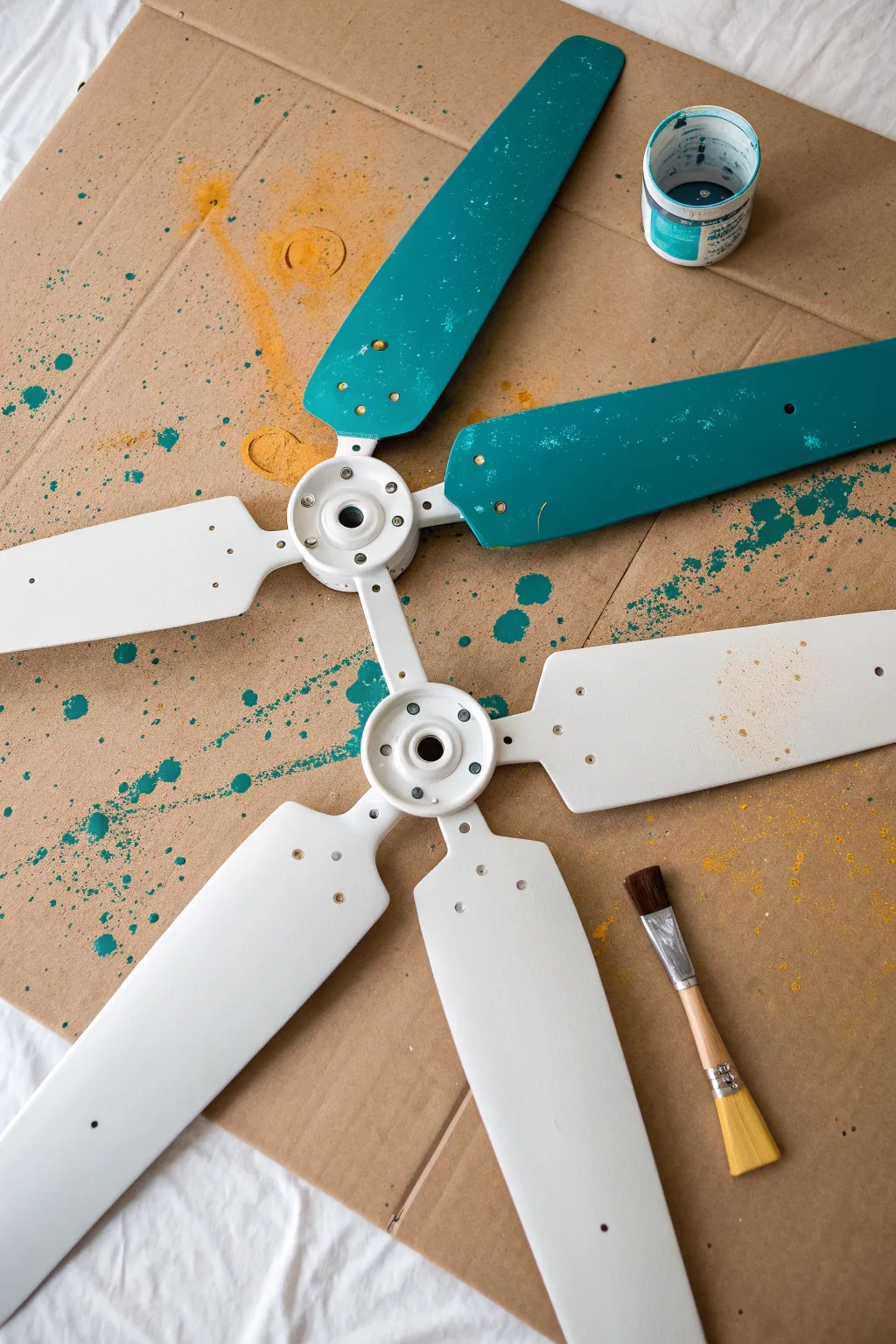 Studio-style splatter paint turns plain ceiling fan blades into a bold, modern focal detail.
