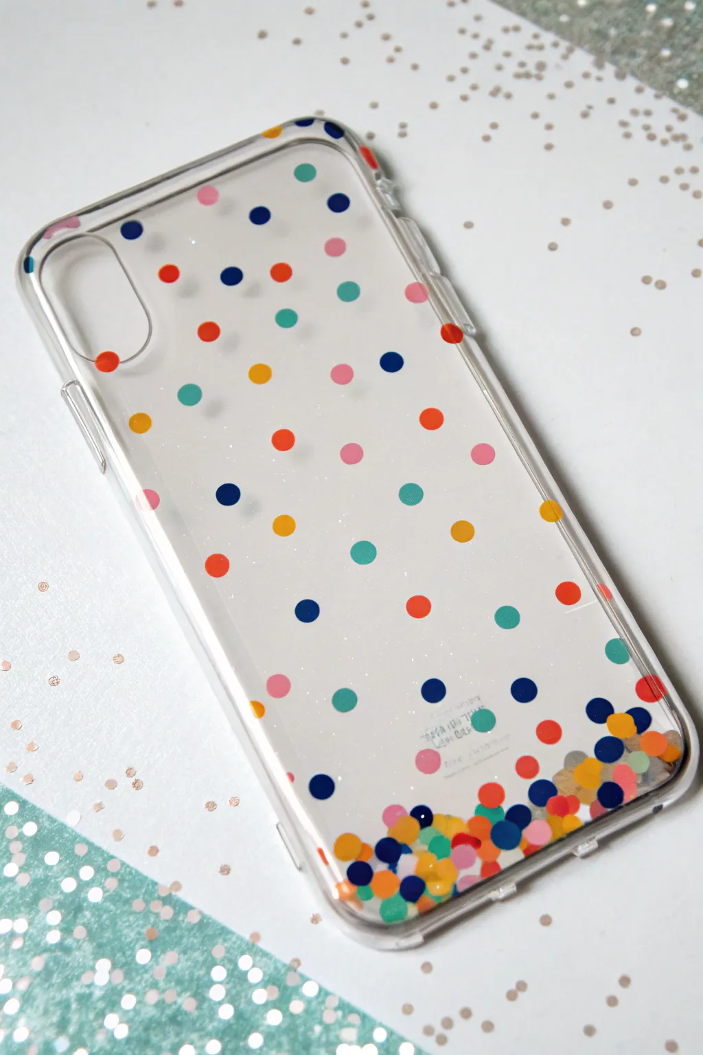 Glitter confetti dots fade upward on a clear phone case for a bold, minimal DIY look