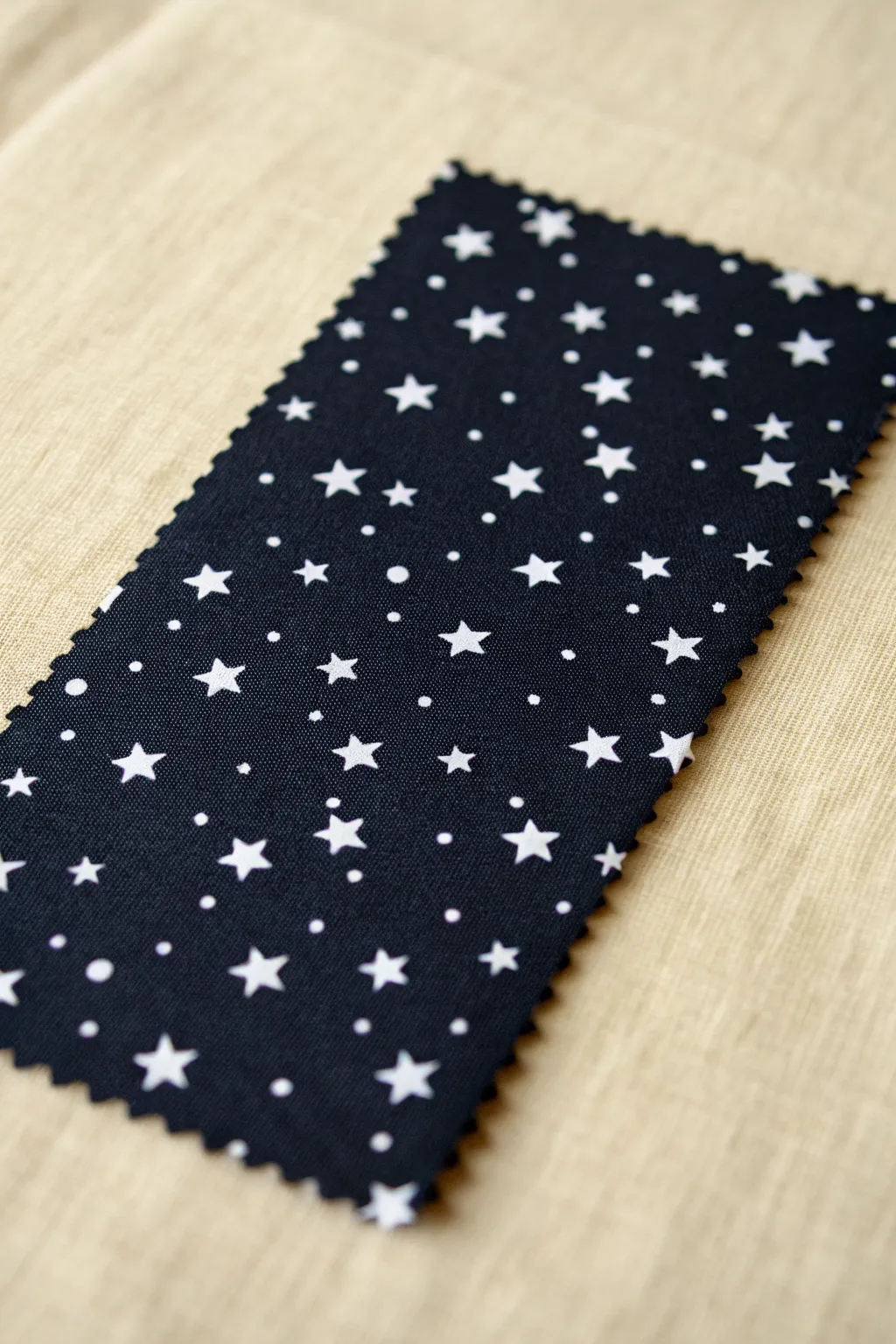 Bold black swatch with crisp white negative-space stars and diamonds for modern pattern inspo.