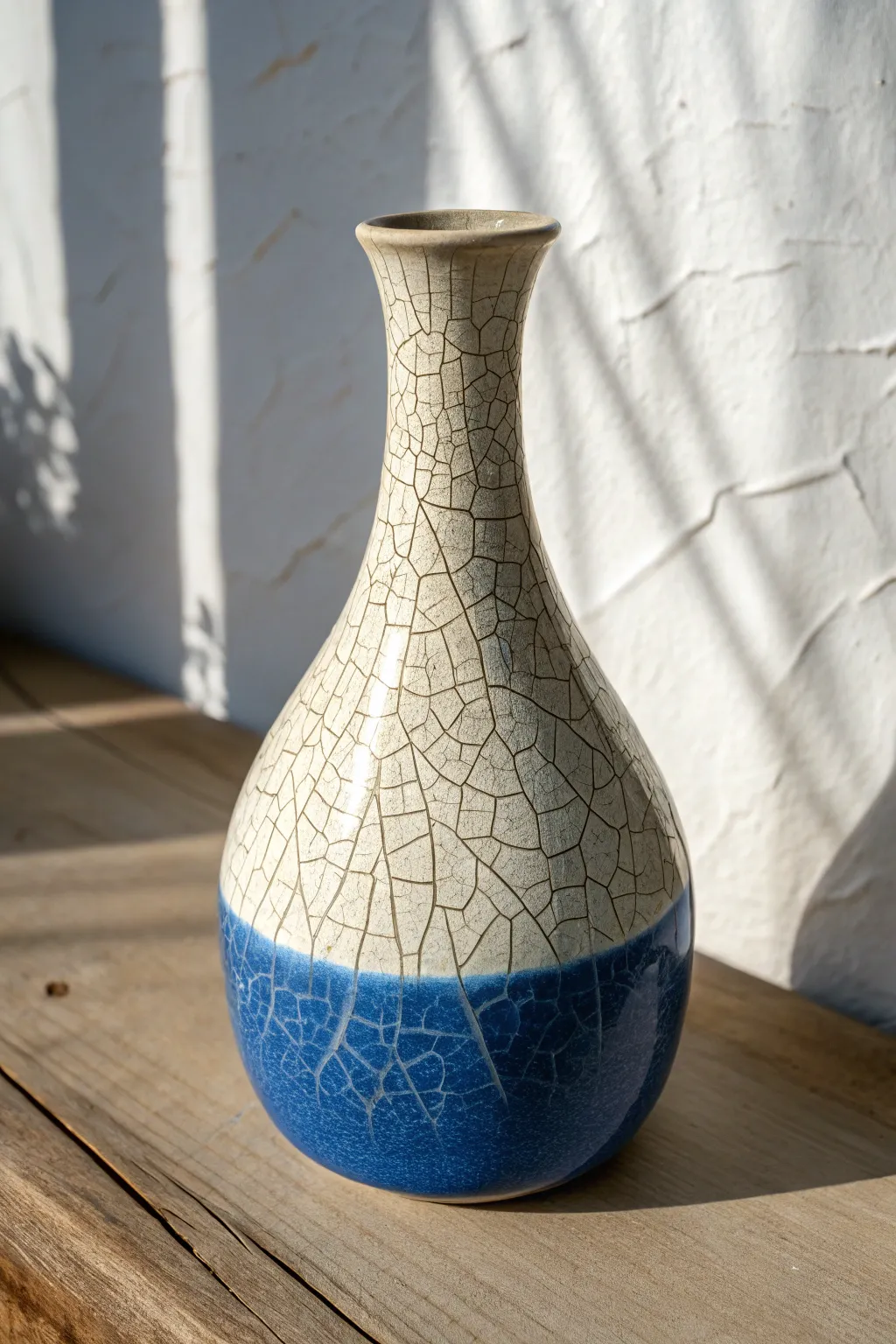 Crackle glaze on a curved vase reveals delicate texture across highlights and shadows in bold color.