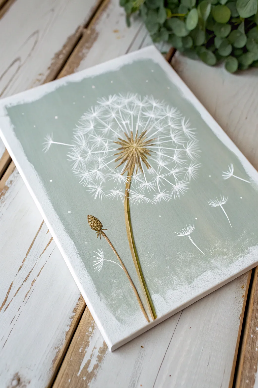 Minimal dandelion seed painting with floating gold leaf accents for an elegant boho touch