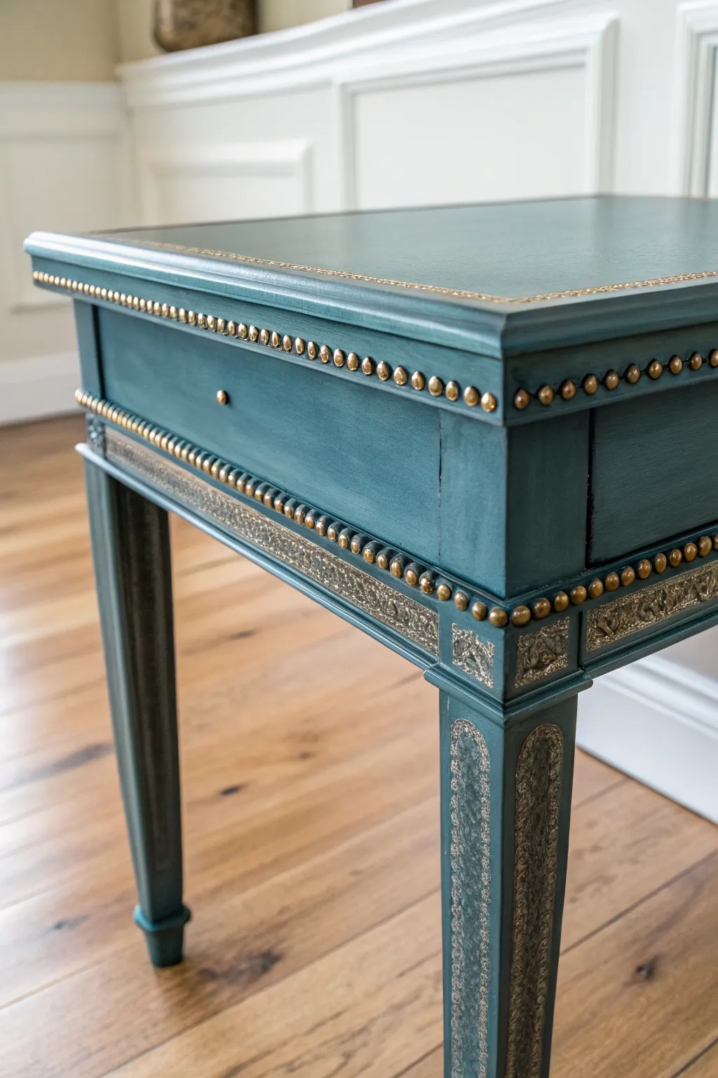 DIY end table detail with brushed gold highlights catching the light on carved trim.