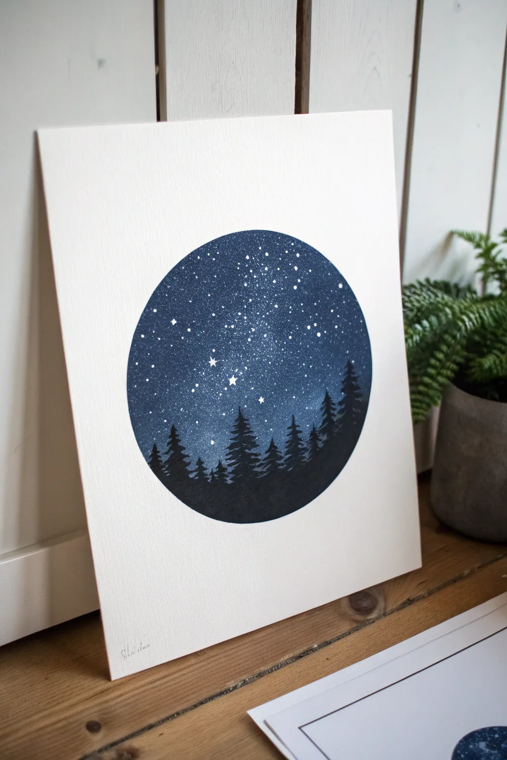 Minimal night-sky circle sketch with uneven stars and a crisp treeline, cozy and bold.