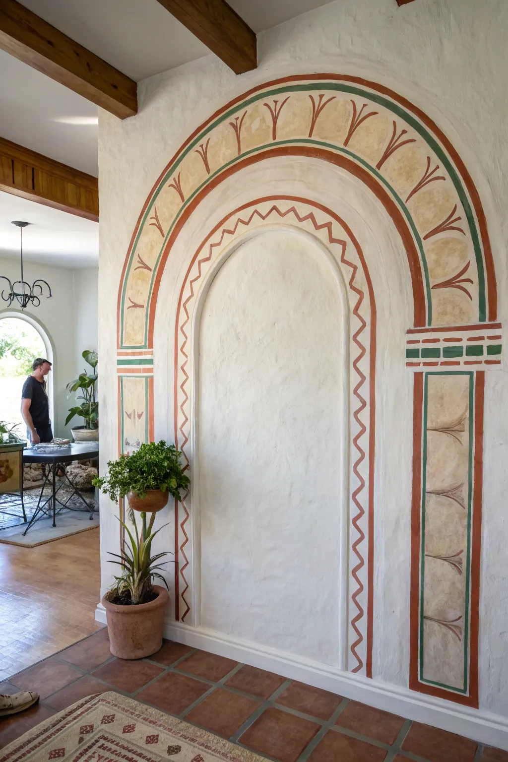 Hand-painted arch mural adds bold, welcoming color to a calm minimalist foyer wall.