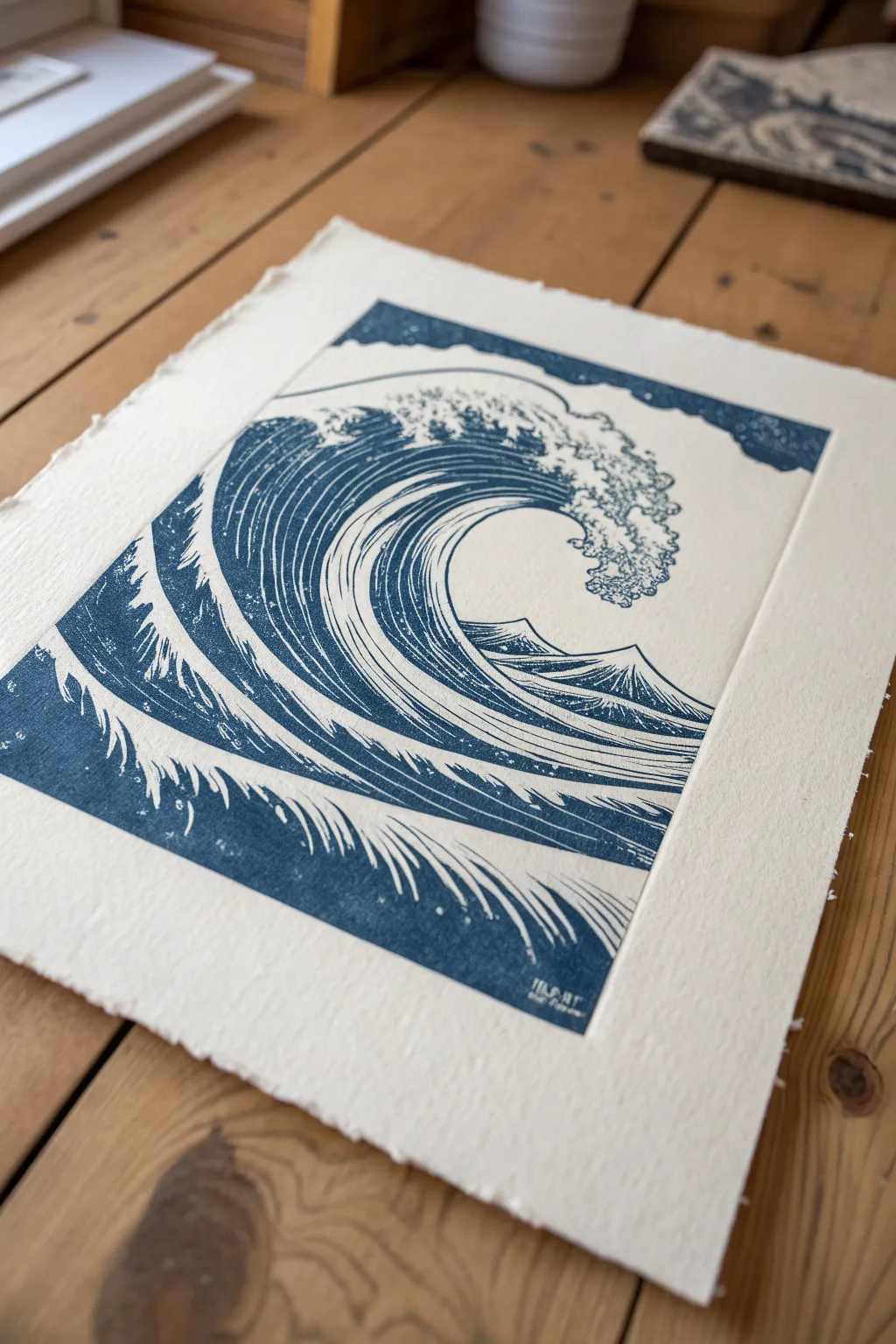 Ocean wave white-line linocut inspiration: bold indigo curl with lively carved foam lines.