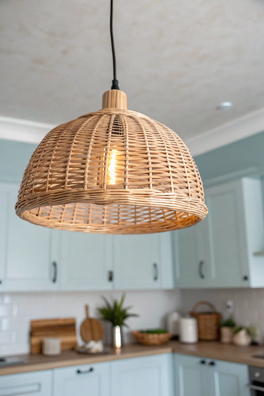 Soft sky-blue ceiling paint and a warm pendant glow create an instant cozy kitchen mood.