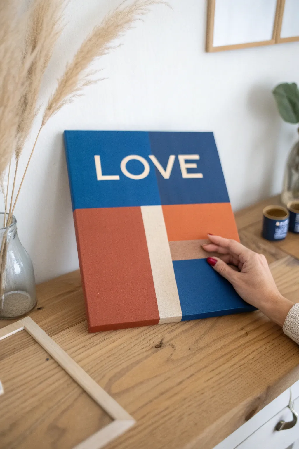 Peel back the tape to reveal a crisp LOVE message on bold color blocks, minimalist with boho warmth
