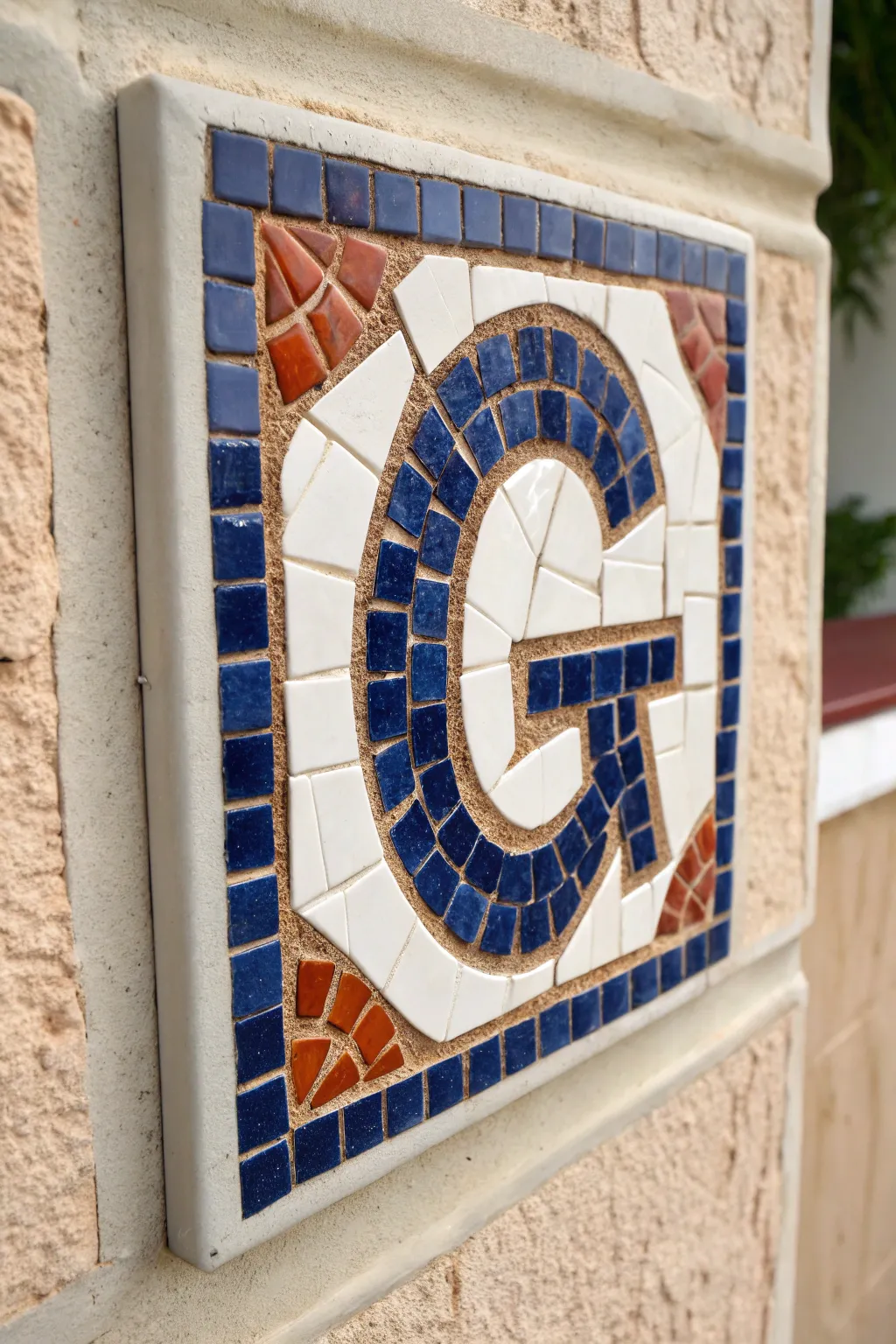Crisp, high-contrast mosaic monogram close-up with clean grout lines and handcrafted tile texture.