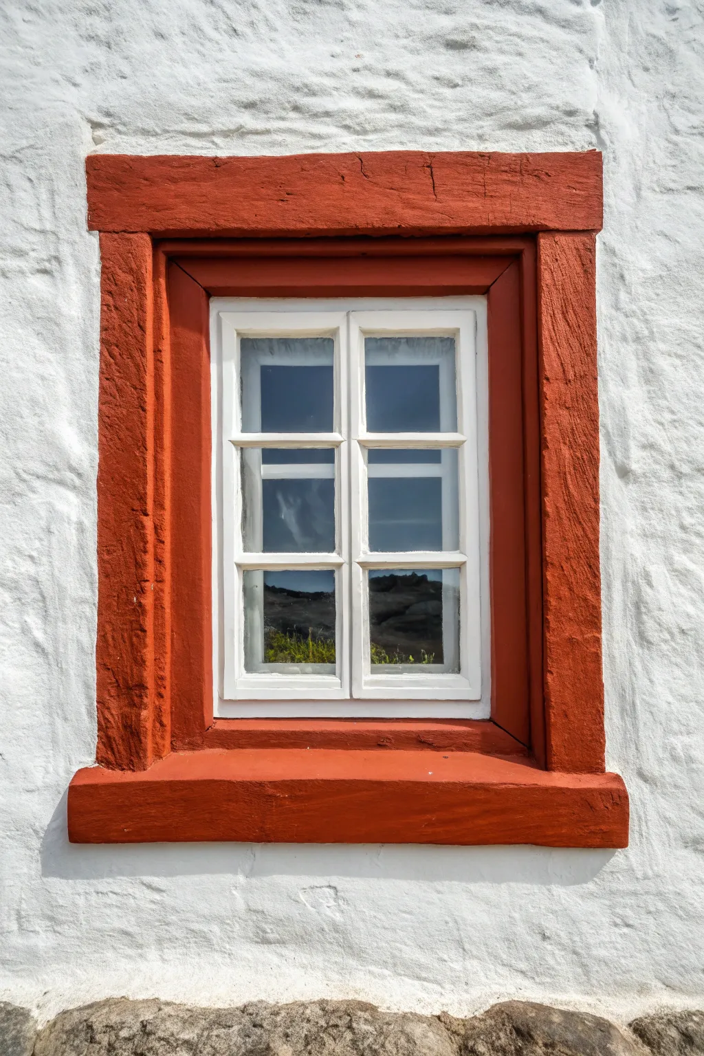 Painted border trick makes this window look grander, simple DIY molding illusion with bold color.