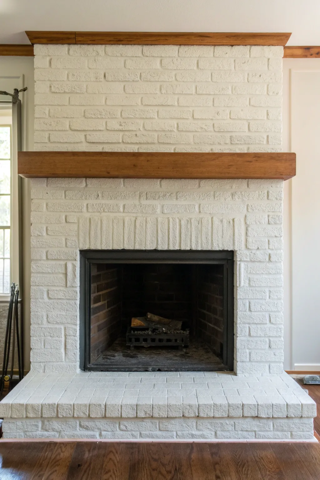 Crisp painted brick border framing the firebox for a bold, minimalist fireplace refresh.