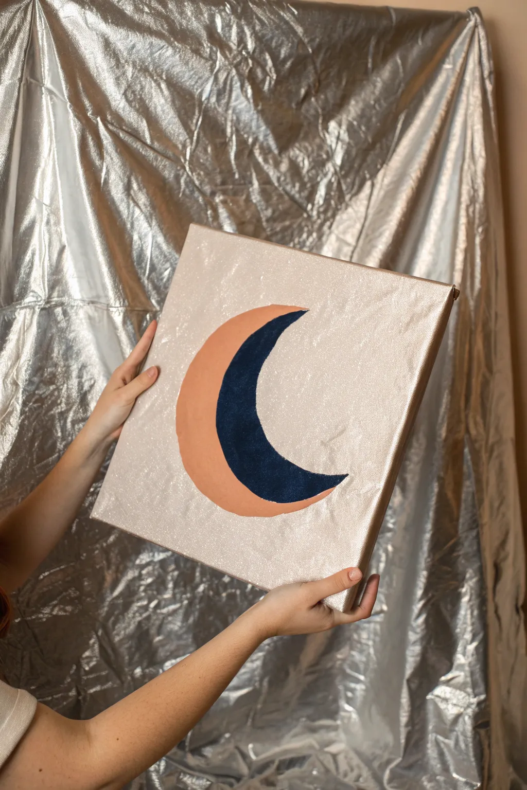 DIY metallic foil background painting with a matte moon for shimmer-perfect teen room photos.