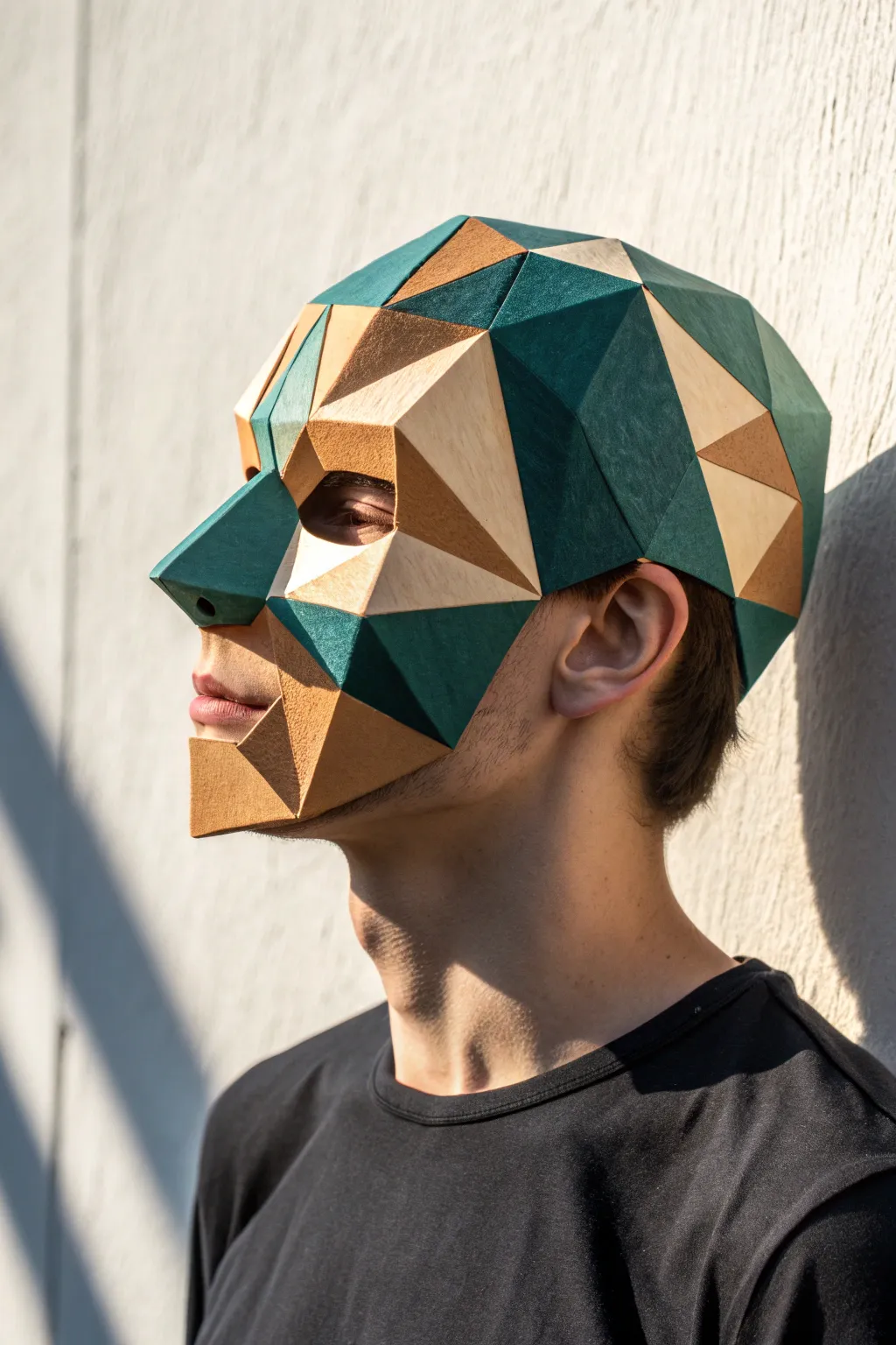 Geometric low-poly paper mache mask with bold color blocks and crisp shadows for modern DIY decor