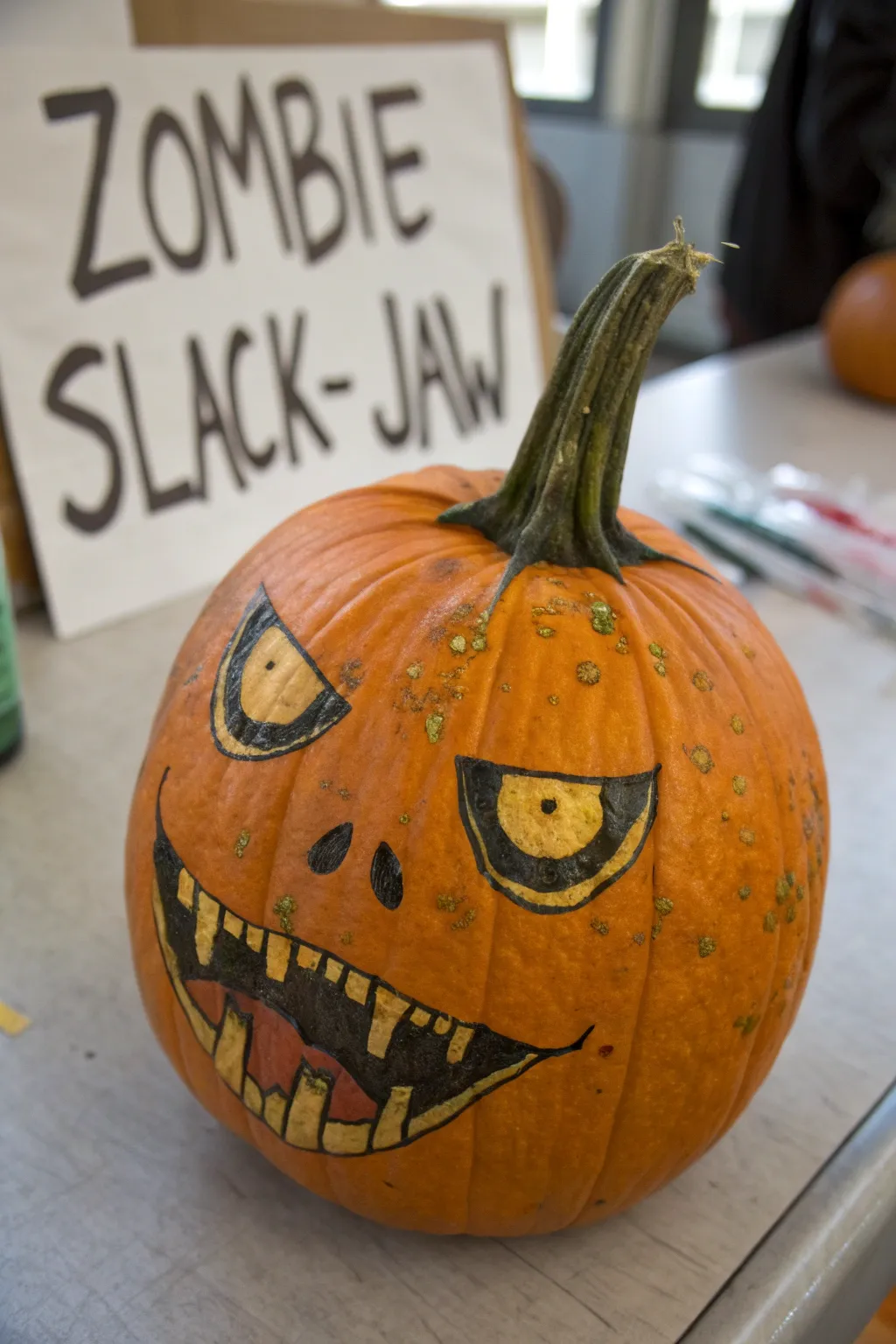 Zombie slack-jaw pumpkin face with drool and green-gray skin patches for spooky drawing inspo