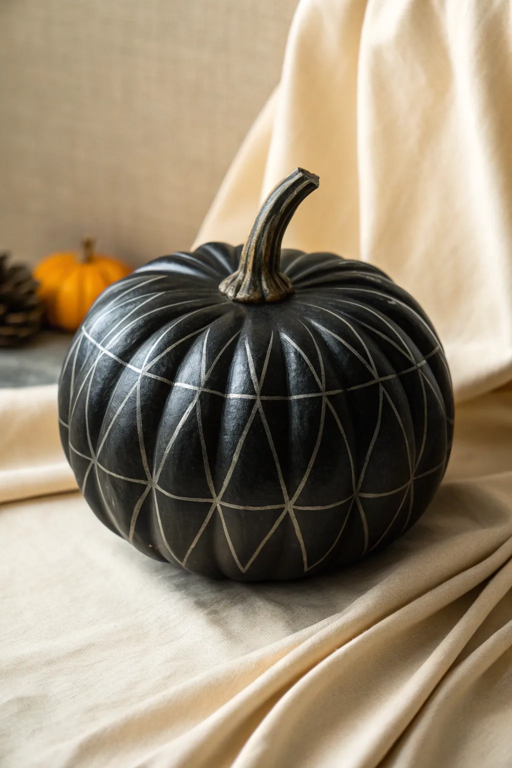 Matte black pumpkin with glossy hidden pattern, bold minimal style and striking contrast.