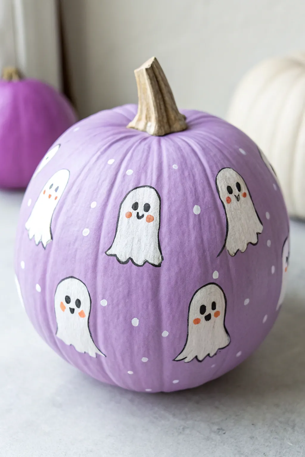 A cheerful purple pumpkin with tiny floating ghosts for a cute, bright Halloween vibe.