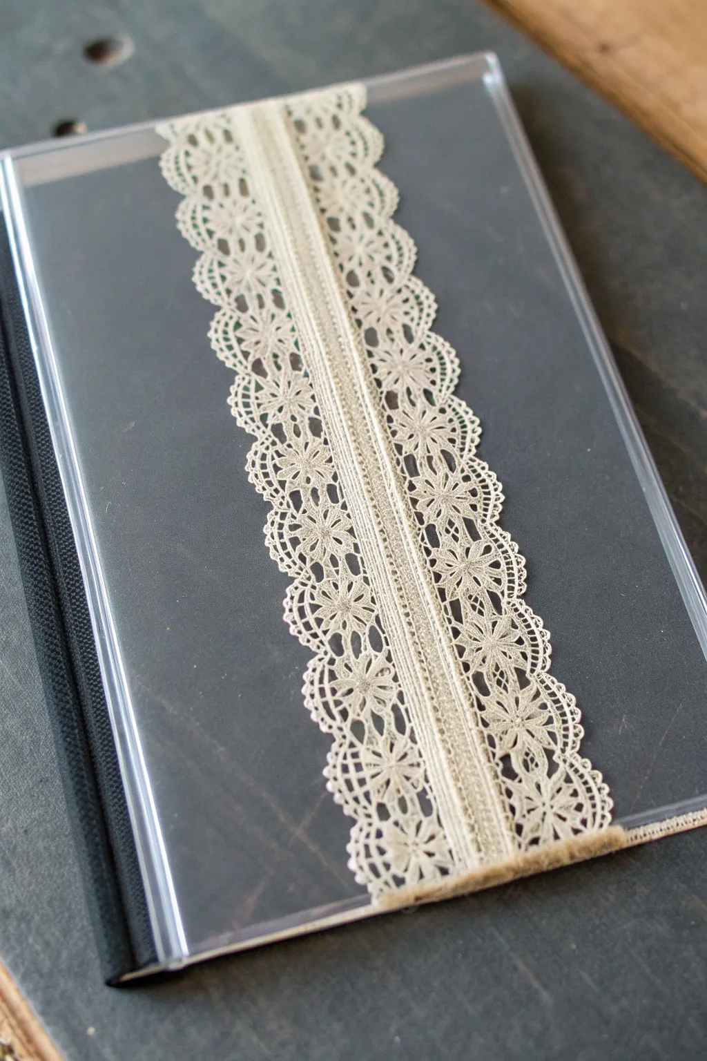 Lace suspended in crystal-clear resin, a minimalist notebook cover with boho texture.