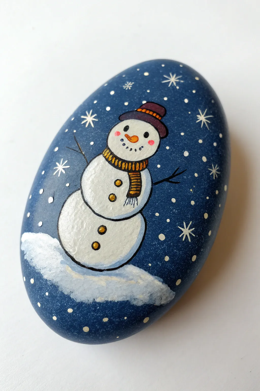 Midnight-blue snowman rock with glowing snow highlights for a dreamy minimalist winter-night craft.