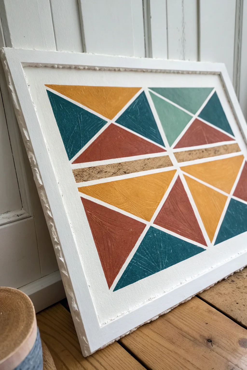 Torn-edge tape turns clean geometry into earthy, handcrafted texture with bold color contrast